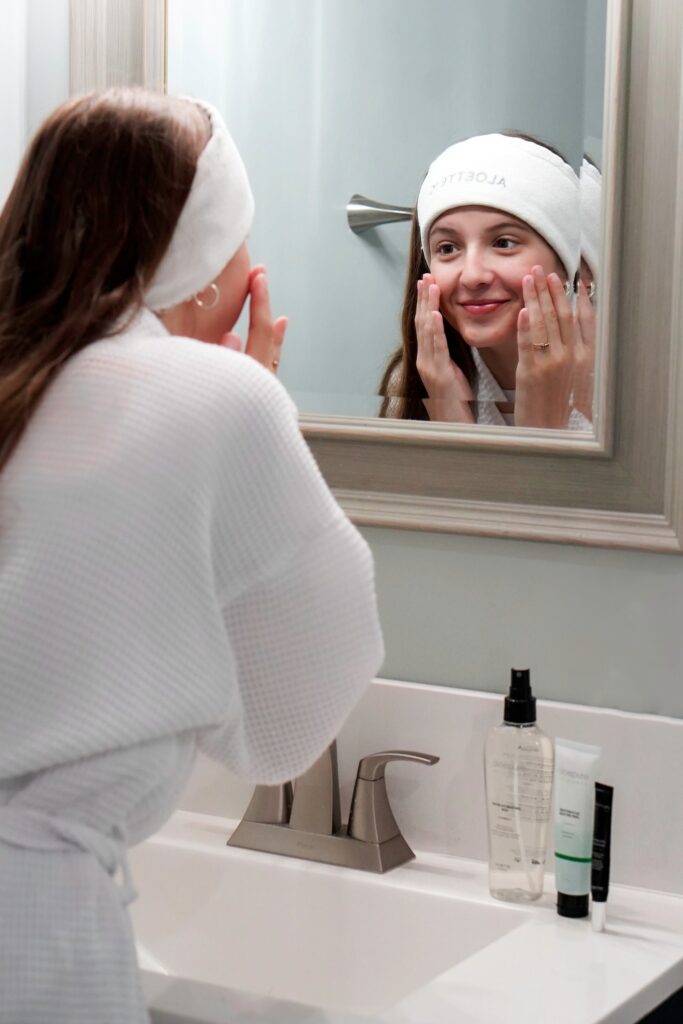 Woman washing face with Aloette skincare