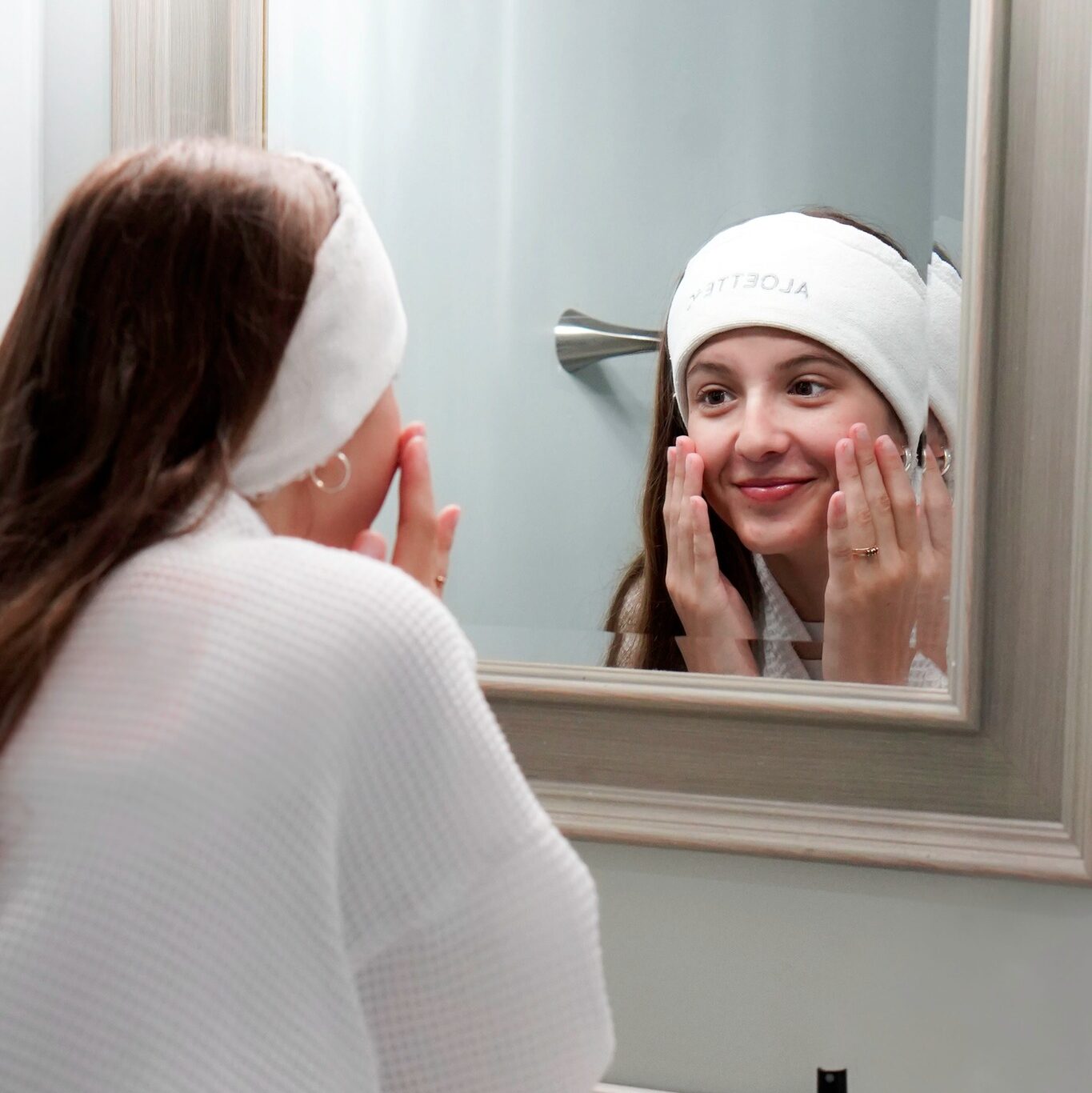 Woman washing face with Aloette skincare