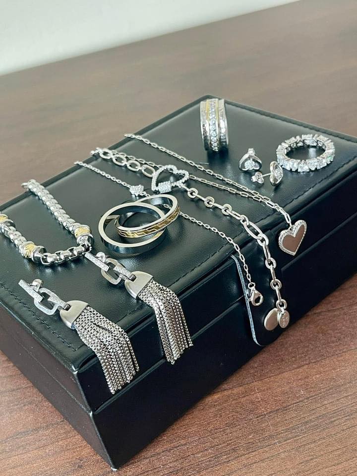 Various pieces of tocara jewelry laying over top of black jewelry box