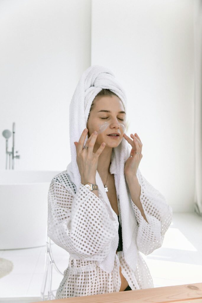 Photo Of Woman Applying Cosmetics On Her Face